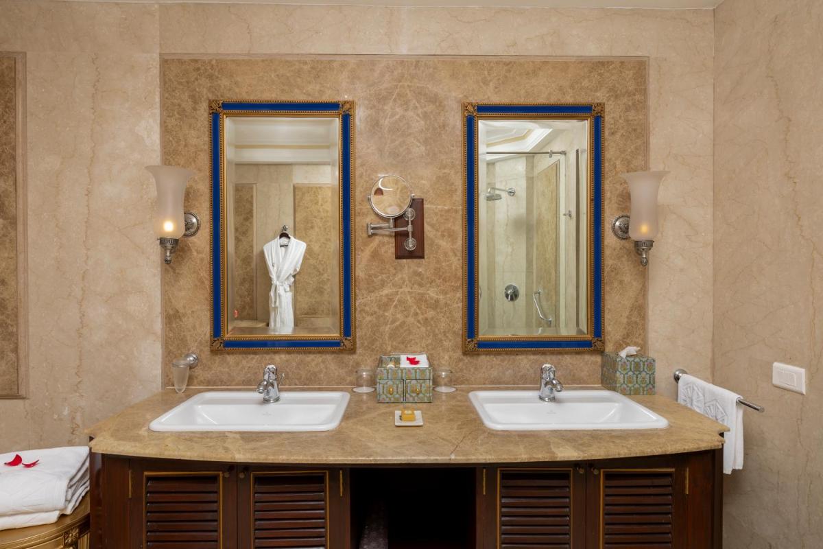 a bathroom with two sinks and a mirror at Taj Fateh Prakash Palace Udaipur in Udaipur
