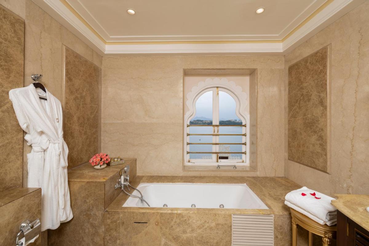 a bathroom with a tub and a window at Taj Fateh Prakash Palace Udaipur in Udaipur