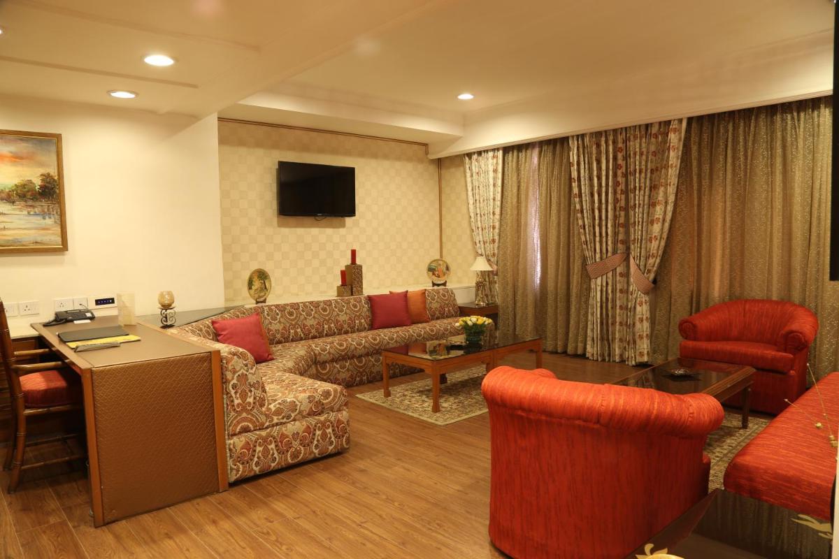 a living room with a couch and a table at The Ashok, New Delhi in New Delhi a living room with a couch and a table at The Ashok, New Delhi in New Delhi