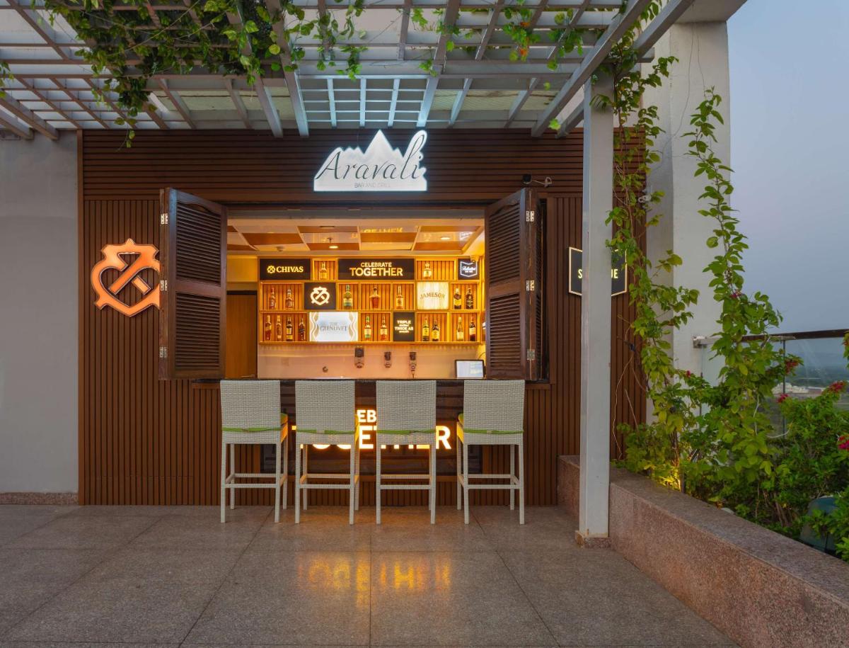 a restaurant with a table and chairs in front of it at DoubleTree By Hilton Jaipur Amer in Jaipur