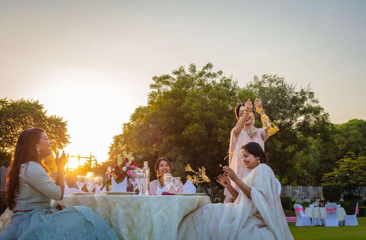 a group of women in dresses sitting around a table at DoubleTree By Hilton Jaipur Amer in Jaipur