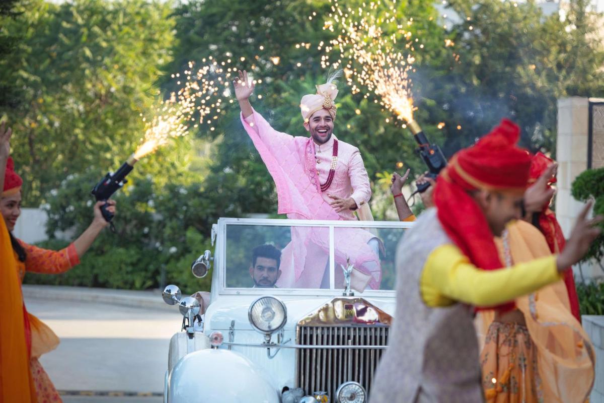 a woman standing in front of a car with sparklers at DoubleTree By Hilton Jaipur Amer in Jaipur