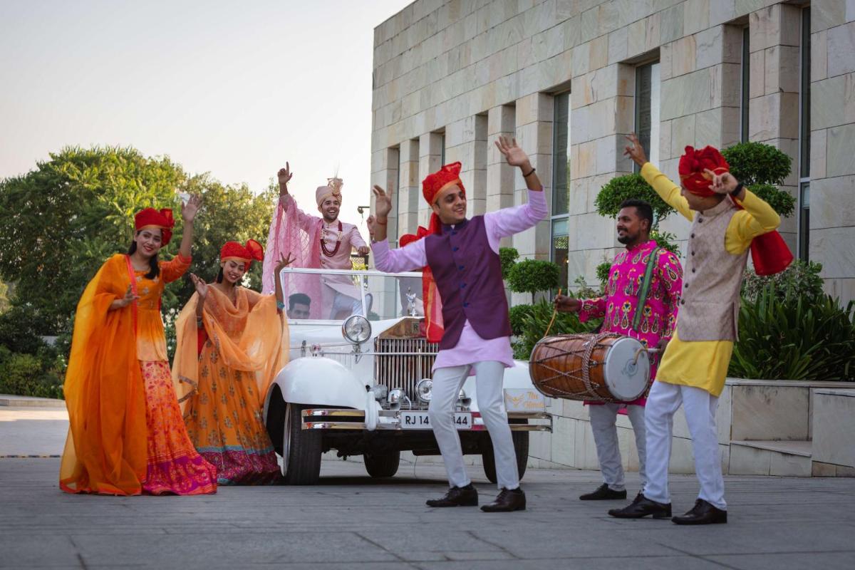 a group of people standing in front of a car at DoubleTree By Hilton Jaipur Amer in Jaipur