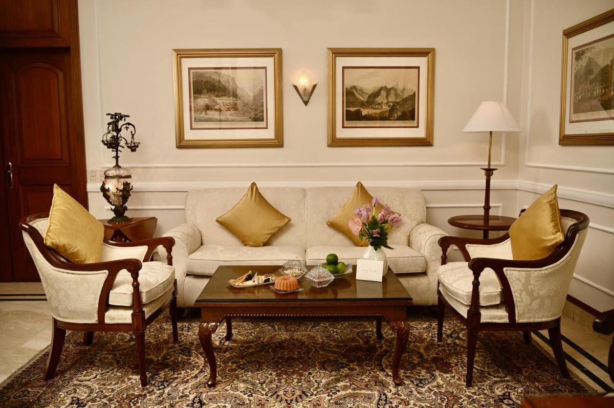 a living room with a couch and two chairs at The Imperial, New Delhi in New Delhi a living room with a couch and two chairs at The Imperial, New Delhi in New Delhi