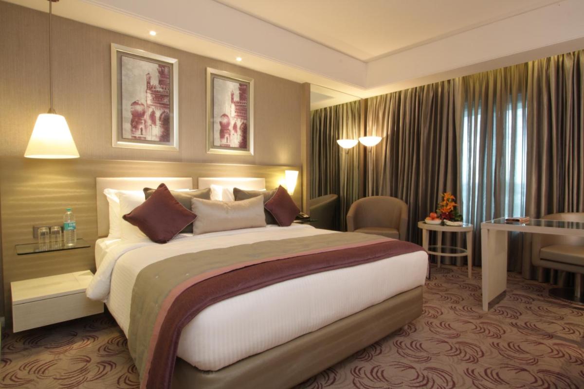 a bedroom with a large bed in a hotel room at Radisson Hyderabad Hitec City in Hyderabad