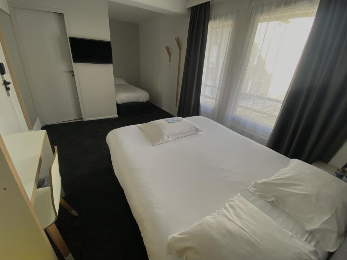 Un ou plusieurs lits dans un hébergement de l'établissement Kyriad Hotel Brest
