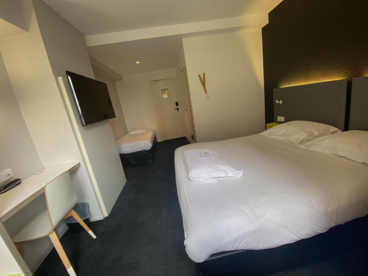 Un ou plusieurs lits dans un hébergement de l'établissement Kyriad Hotel Brest