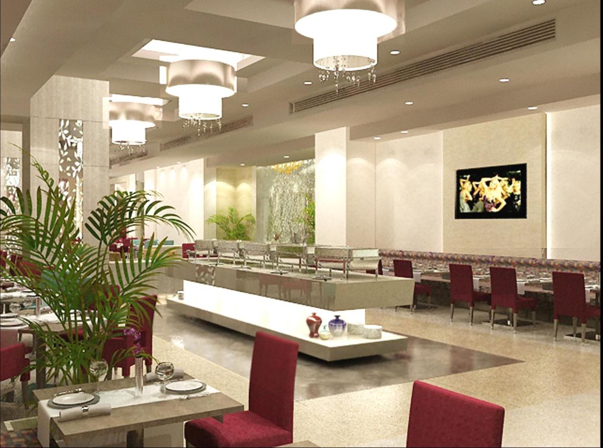a dining room with red chairs and tables in a restaurant at Radisson Hyderabad Hitec City in Hyderabad