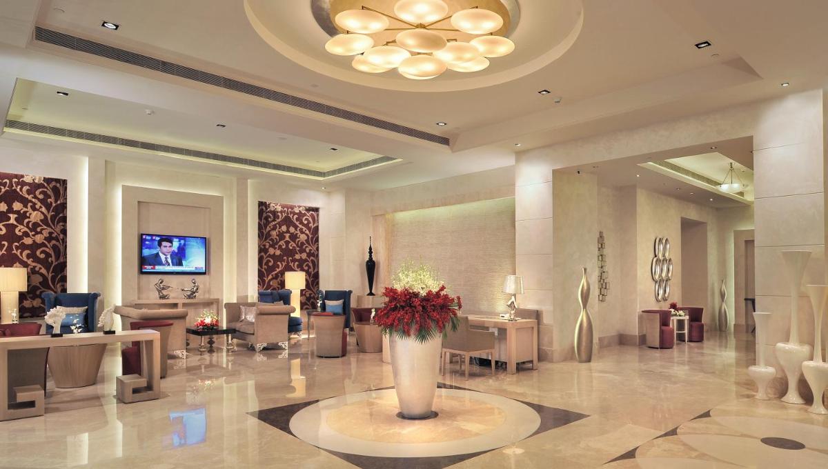 a lobby with a vase of flowers in a room at Radisson Hyderabad Hitec City in Hyderabad