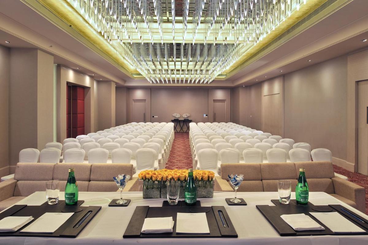 a conference room with a long table and chairs at Radisson Hyderabad Hitec City in Hyderabad