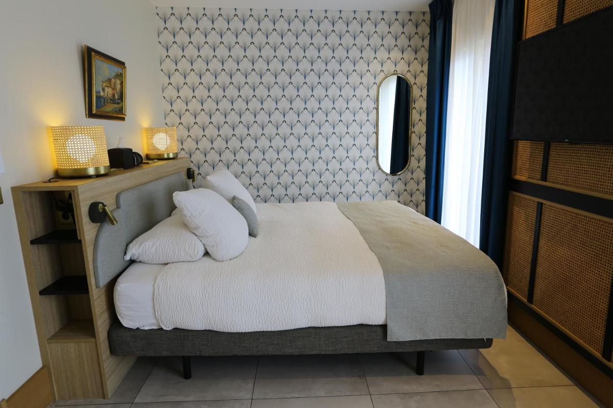 Un ou plusieurs lits dans un hébergement de l'établissement Splendid Hôtel & Spa