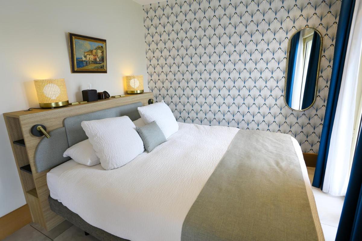 Un ou plusieurs lits dans un hébergement de l'établissement Splendid Hôtel & Spa