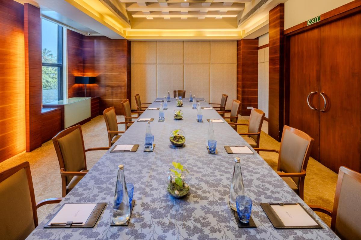a large conference room with a long table with chairs at Vivanta Goa, Panaji in Panaji a large conference room with a long table with chairs at Vivanta Goa, Panaji in Panaji