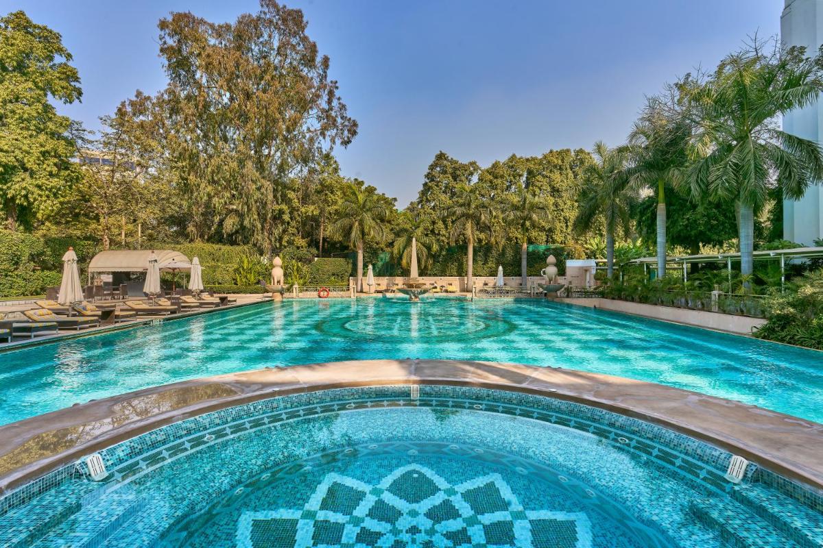 a large swimming pool with blue water at The Imperial, New Delhi in New Delhi a large swimming pool with blue water at The Imperial, New Delhi in New Delhi