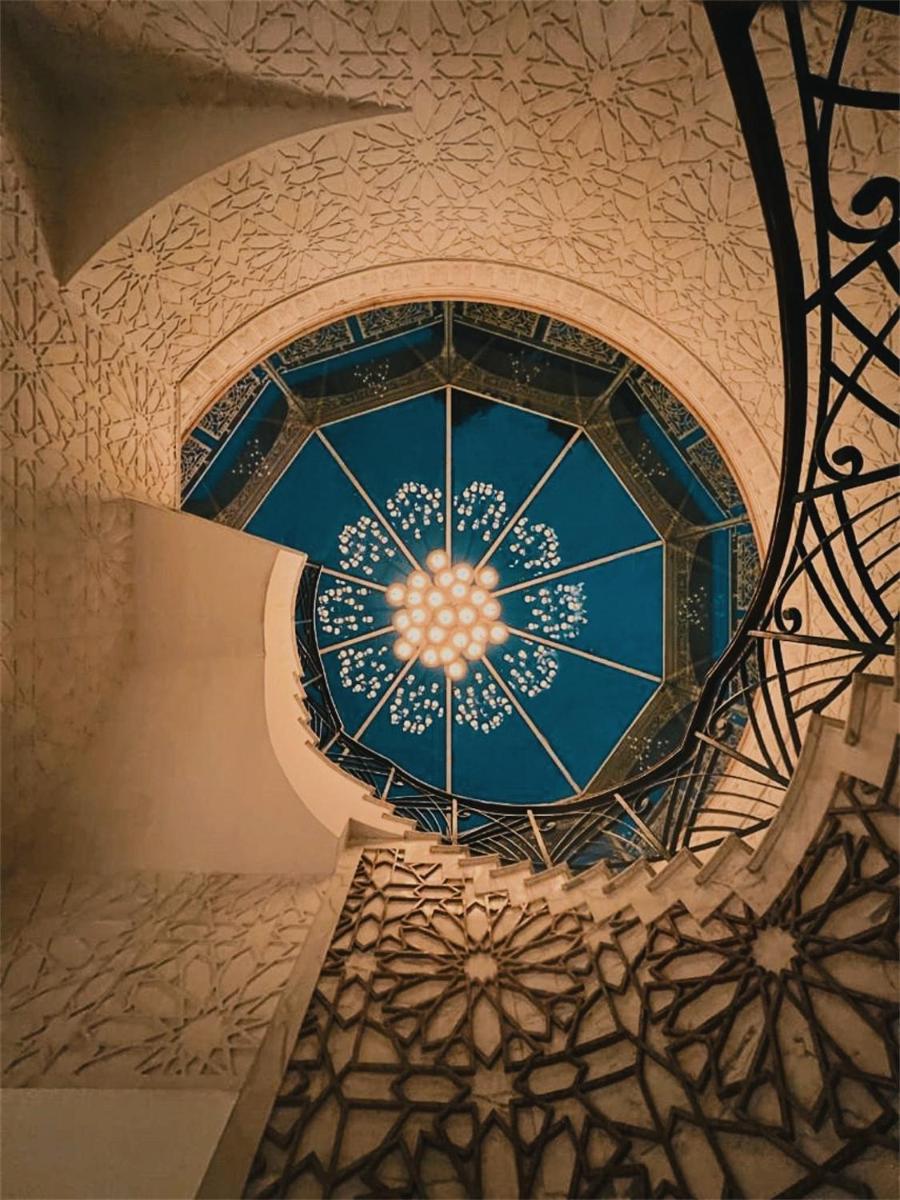 a spiral staircase in a building with a blue ceiling at The Imperial, New Delhi in New Delhi a spiral staircase in a building with a blue ceiling at The Imperial, New Delhi in New Delhi