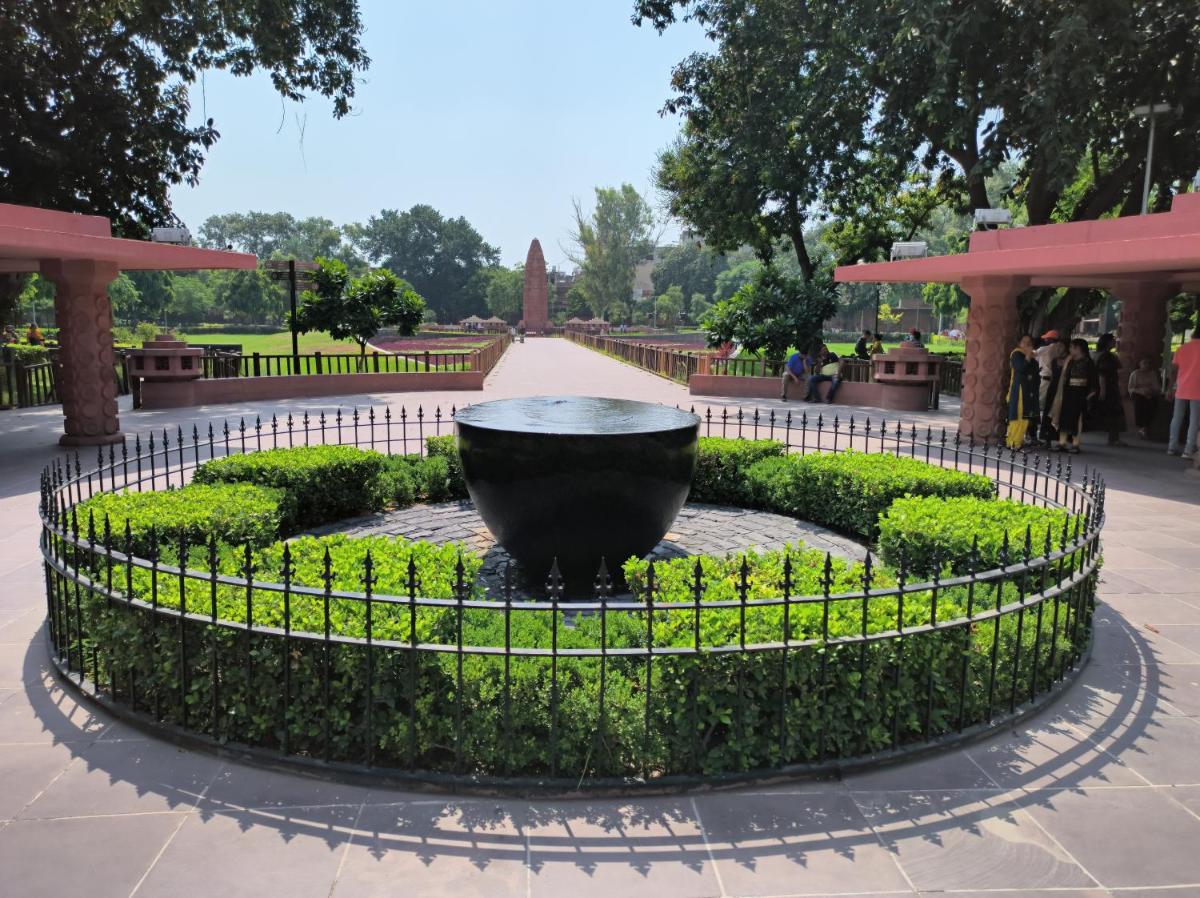 a large black bowl in a park with a fence at Courtyard by Marriott Amritsar in Amritsar