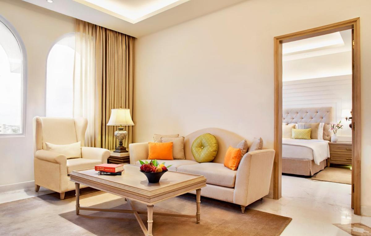 a living room with a couch and a bedroom at Taj Ganges Varanasi in Varanasi