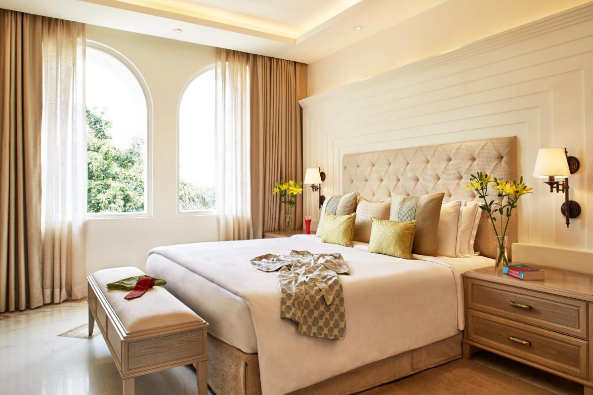 a bedroom with a large bed and a window at Taj Ganges Varanasi in Varanasi