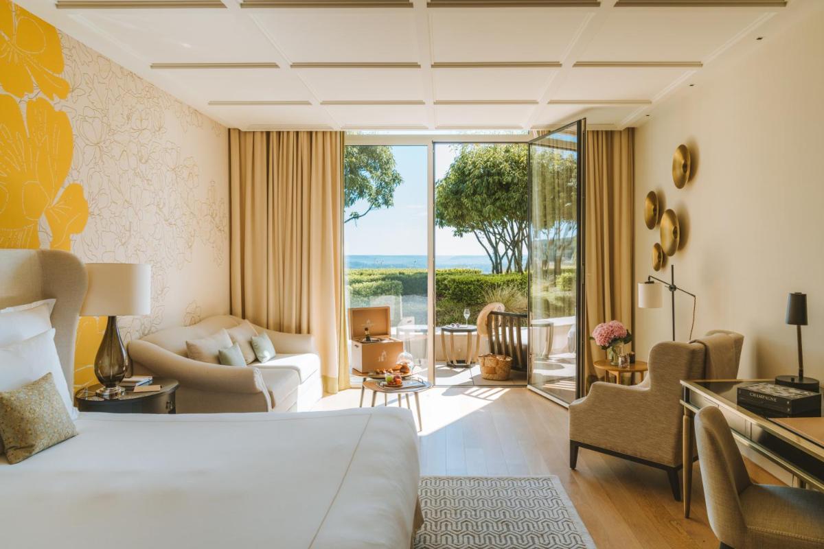 une chambre avec un lit et un salon dans l'établissement Royal Champagne Hotel & Spa, à Champillon