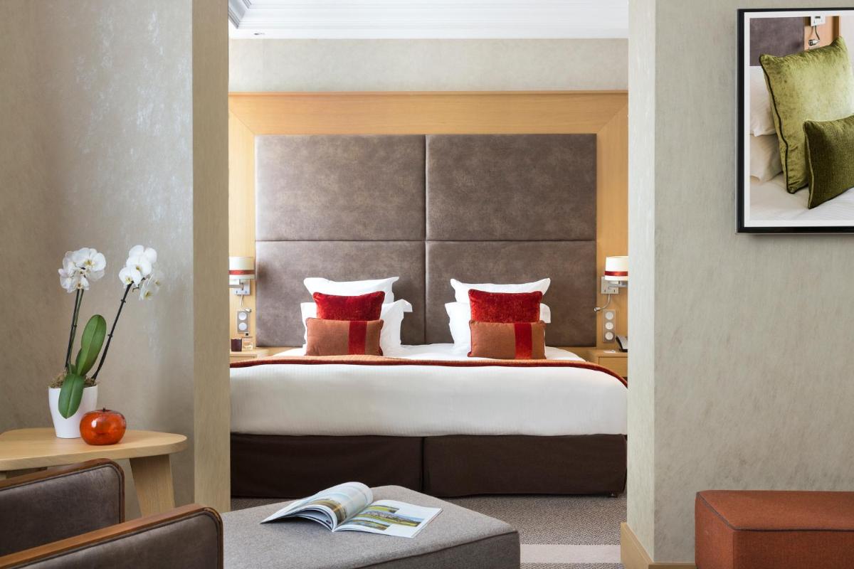 Un ou plusieurs lits dans un hébergement de l'établissement Hôtel Barrière L'Hôtel du Golf