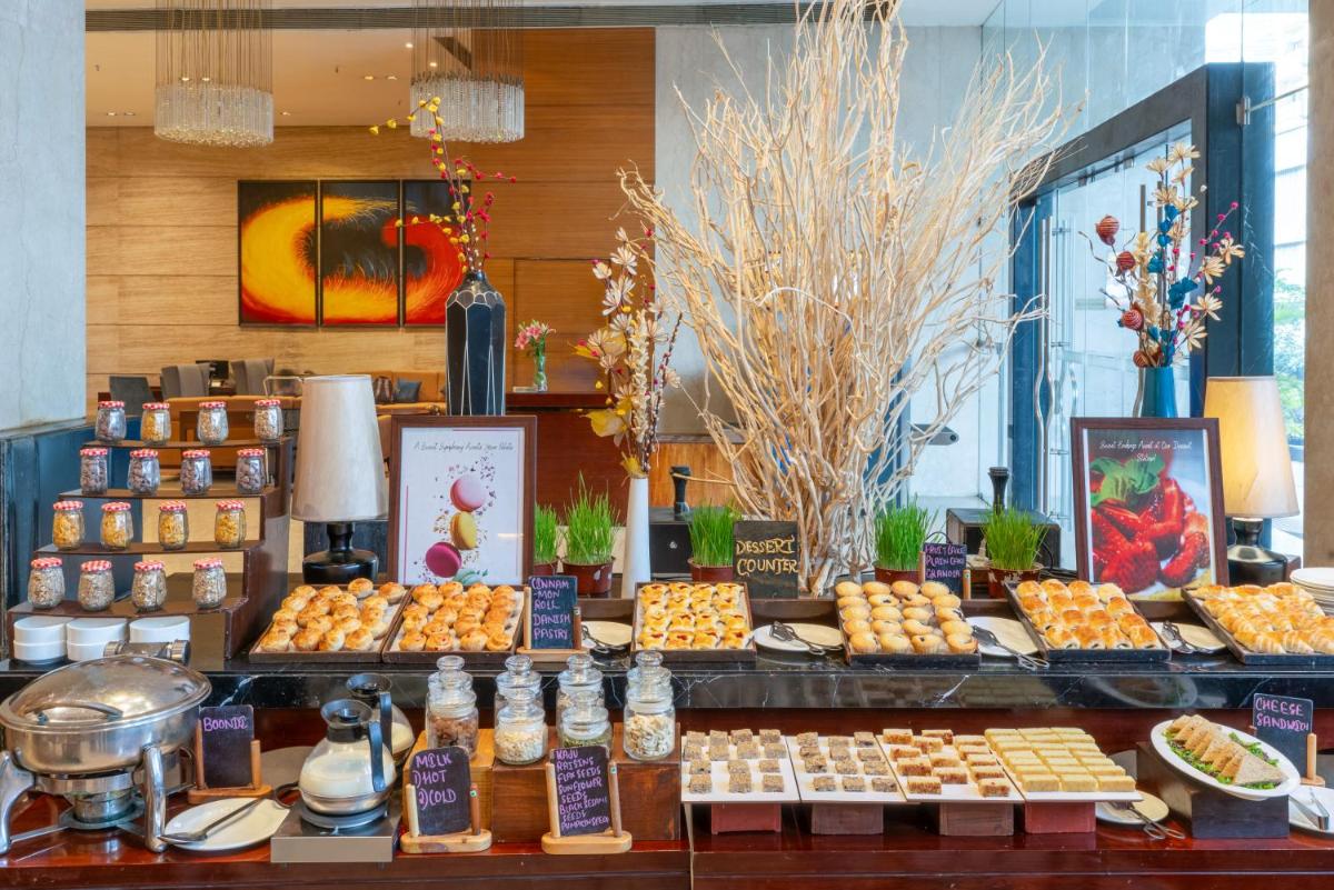 a buffet of food on display in a restaurant at Pride Plaza Hotel, Kolkata in Kolkata