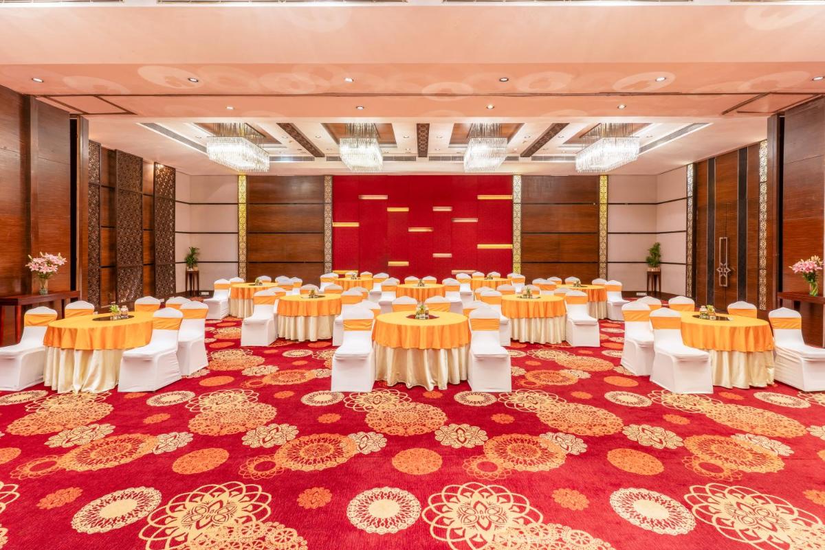 a banquet hall with tables and chairs in a room at Pride Plaza Hotel, Kolkata in Kolkata +78 photos