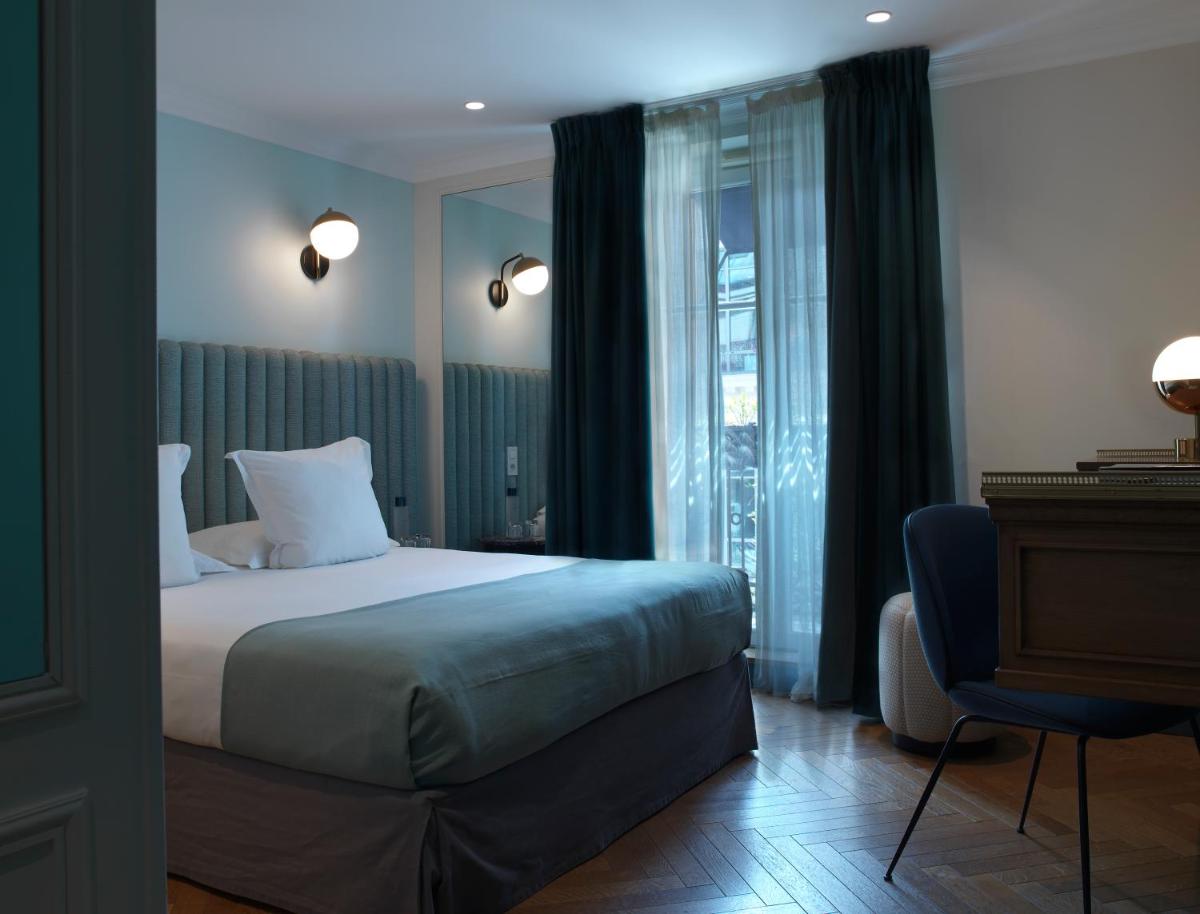 Un ou plusieurs lits dans un hébergement de l'établissement Hotel Bachaumont