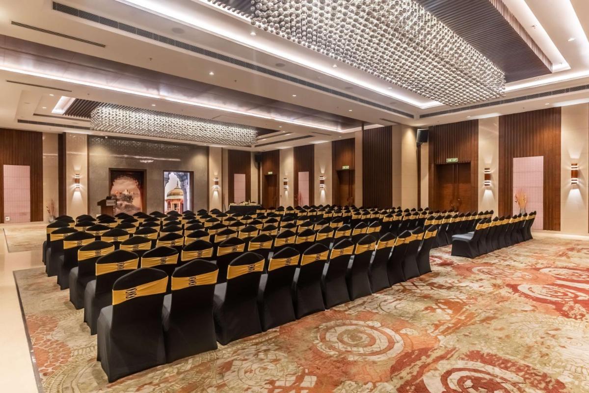 a large room with rows of chairs in it at Radisson Blu Hotel, Greater Noida in Greater Noida