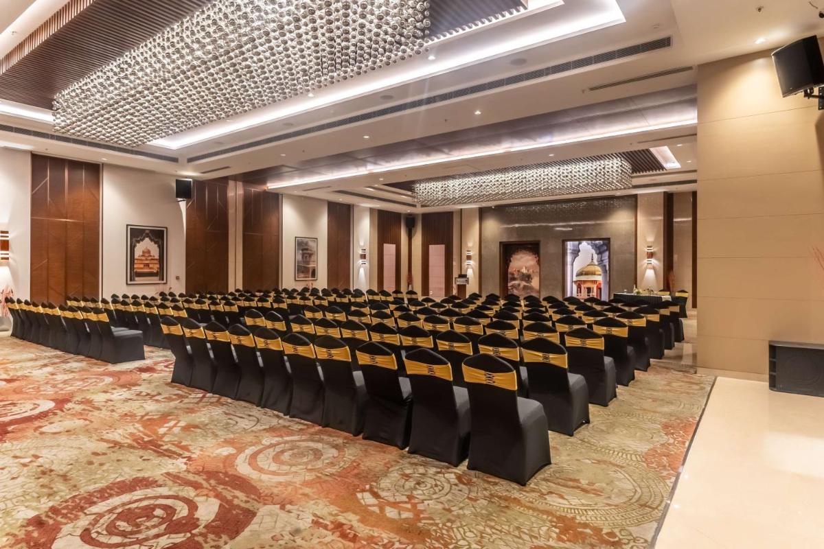 an auditorium with rows of chairs in a building at Radisson Blu Hotel, Greater Noida in Greater Noida