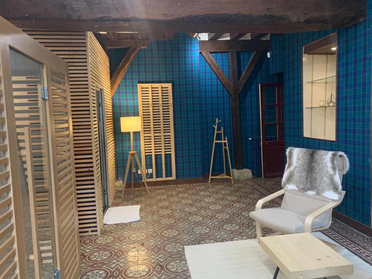 une chambre avec une chaise et un mur bleu dans l'établissement Château de Noizay - ChâteauZen, à Noizay