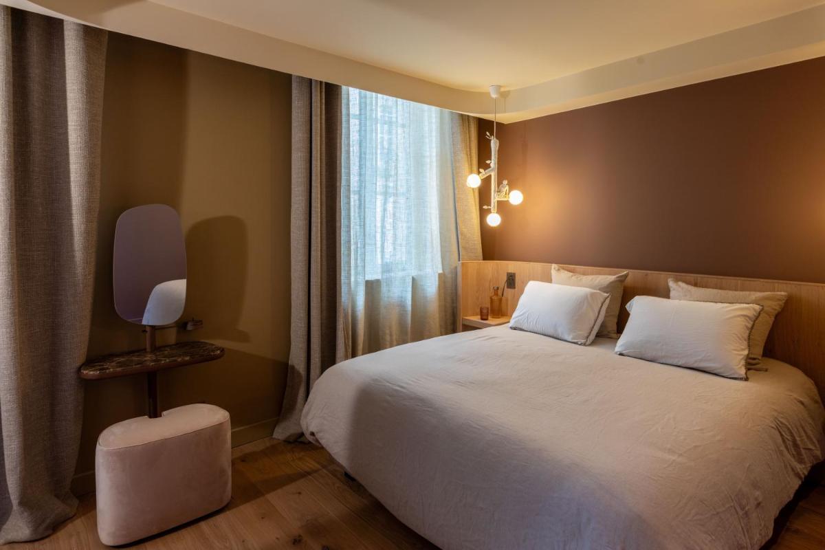 Un ou plusieurs lits dans un hébergement de l'établissement Yndo Hôtel