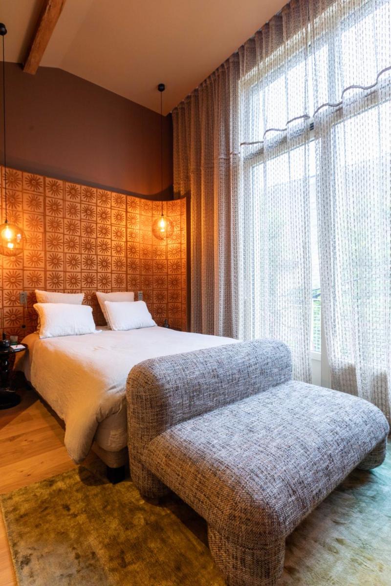 Un ou plusieurs lits dans un hébergement de l'établissement Yndo Hôtel