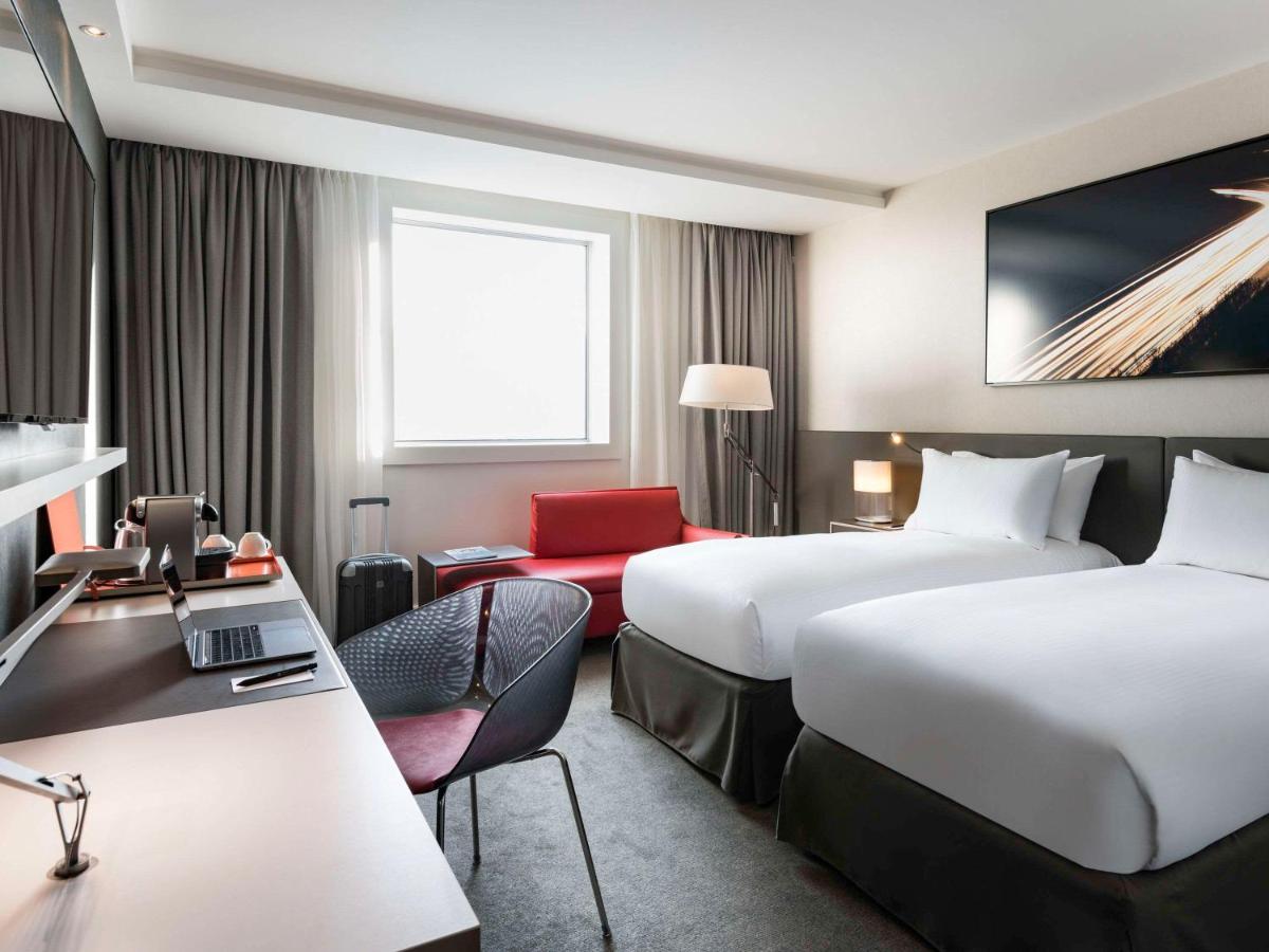 Un ou plusieurs lits dans un hébergement de l'établissement Pullman Paris La Défense
