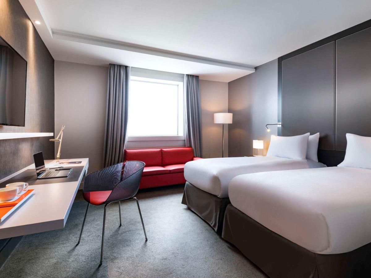 Un ou plusieurs lits dans un hébergement de l'établissement Pullman Paris La Défense