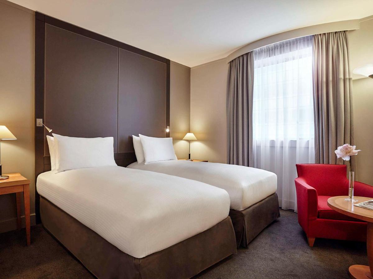 Un ou plusieurs lits dans un hébergement de l'établissement Pullman Paris La Défense