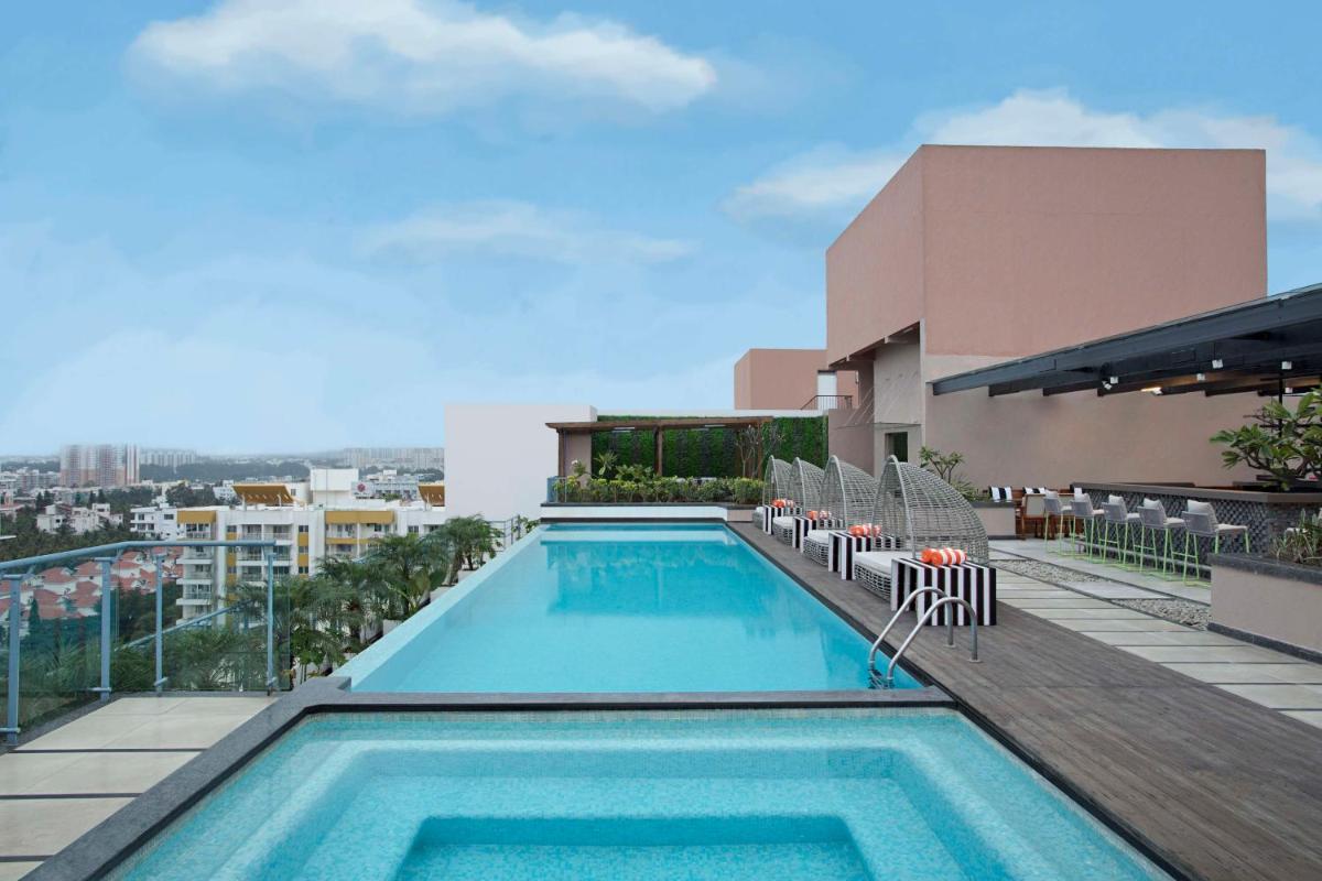a swimming pool on the roof of a building at DoubleTree Suites by Hilton Bengaluru Outer Ring Road in Bengaluru