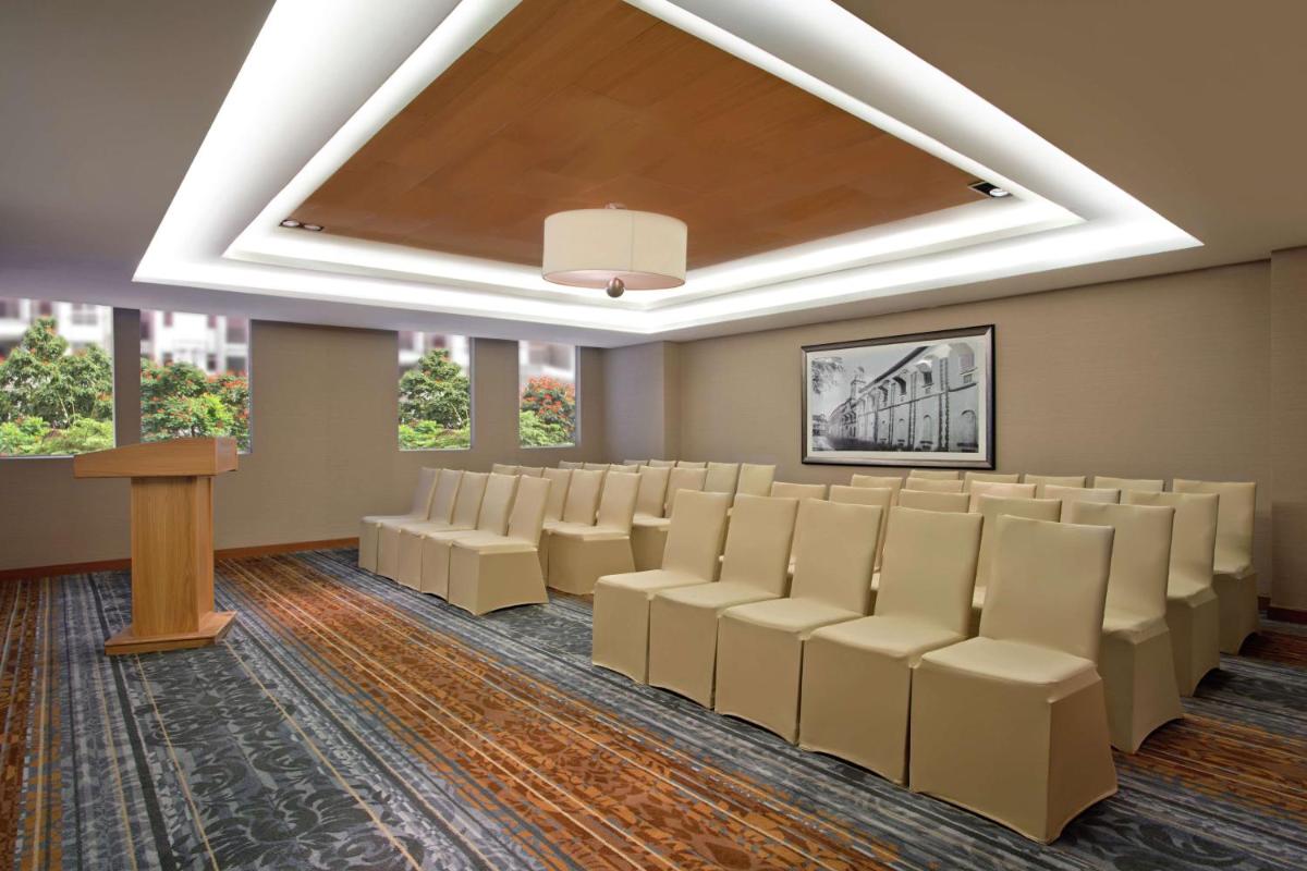 a conference room with chairs and a podium at DoubleTree Suites by Hilton Bengaluru Outer Ring Road in Bengaluru +41 photos