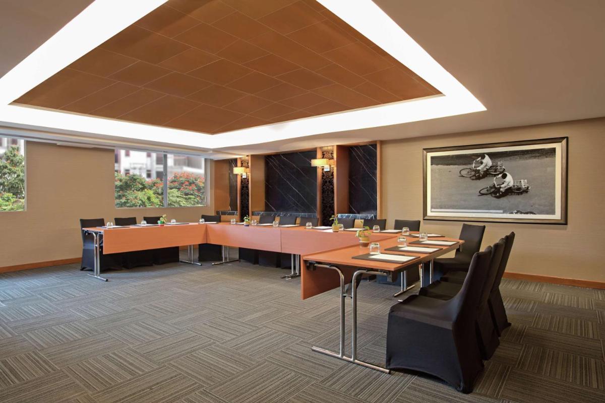 a conference room with a long table and chairs at DoubleTree Suites by Hilton Bengaluru Outer Ring Road in Bengaluru