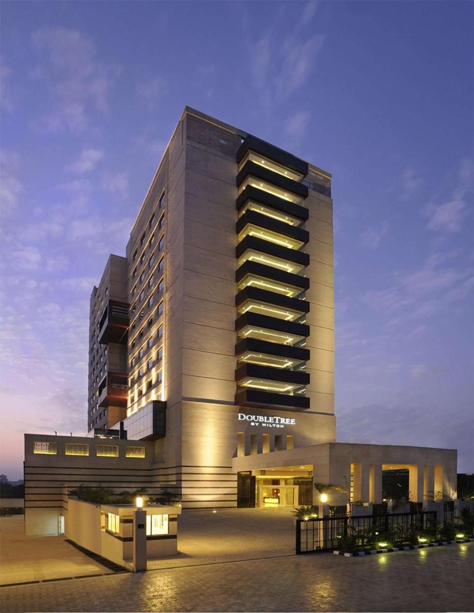 a large building with lights on the side of it at DoubleTree by Hilton Gurgaon New Delhi NCR in Gurgaon a large building with lights on the side of it at DoubleTree by Hilton Gurgaon New Delhi NCR in Gurgaon