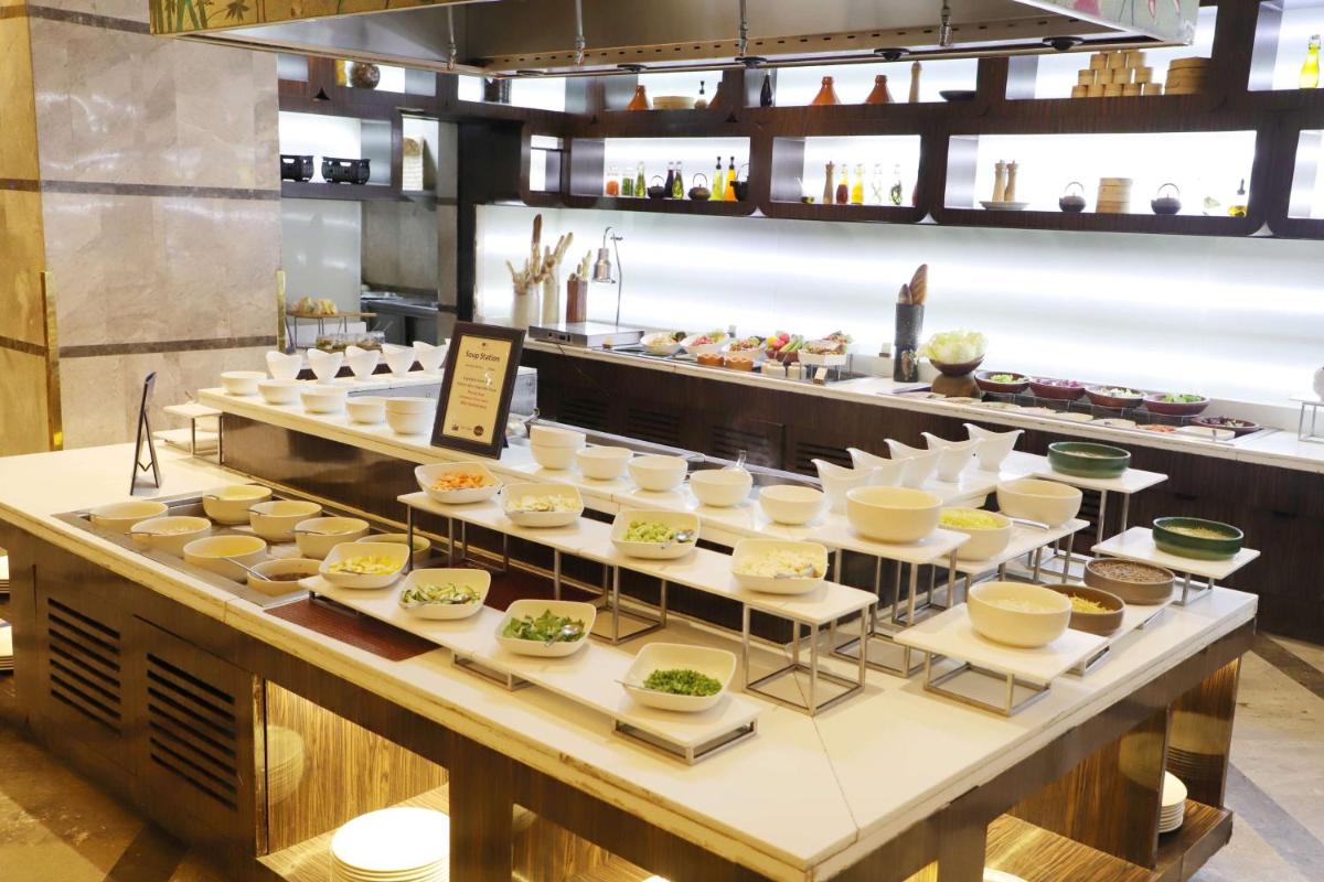 a buffet line with plates of food on display at DoubleTree by Hilton Gurgaon New Delhi NCR in Gurgaon
