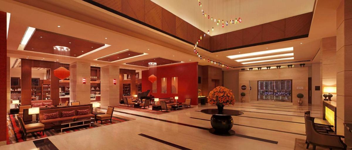 a lobby of a hotel with a piano in it at DoubleTree by Hilton Gurgaon New Delhi NCR in Gurgaon