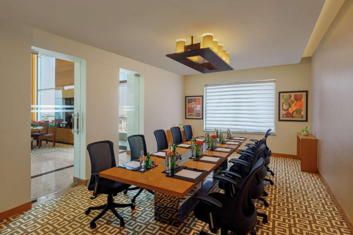a conference room with a long table and chairs at DoubleTree by Hilton Gurgaon New Delhi NCR in Gurgaon