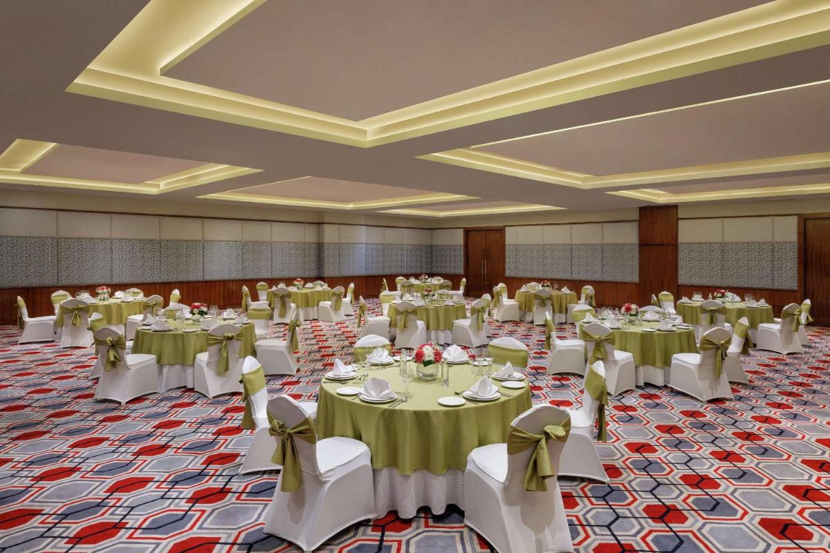 a banquet hall with tables and chairs in a room at DoubleTree by Hilton Gurgaon New Delhi NCR in Gurgaon