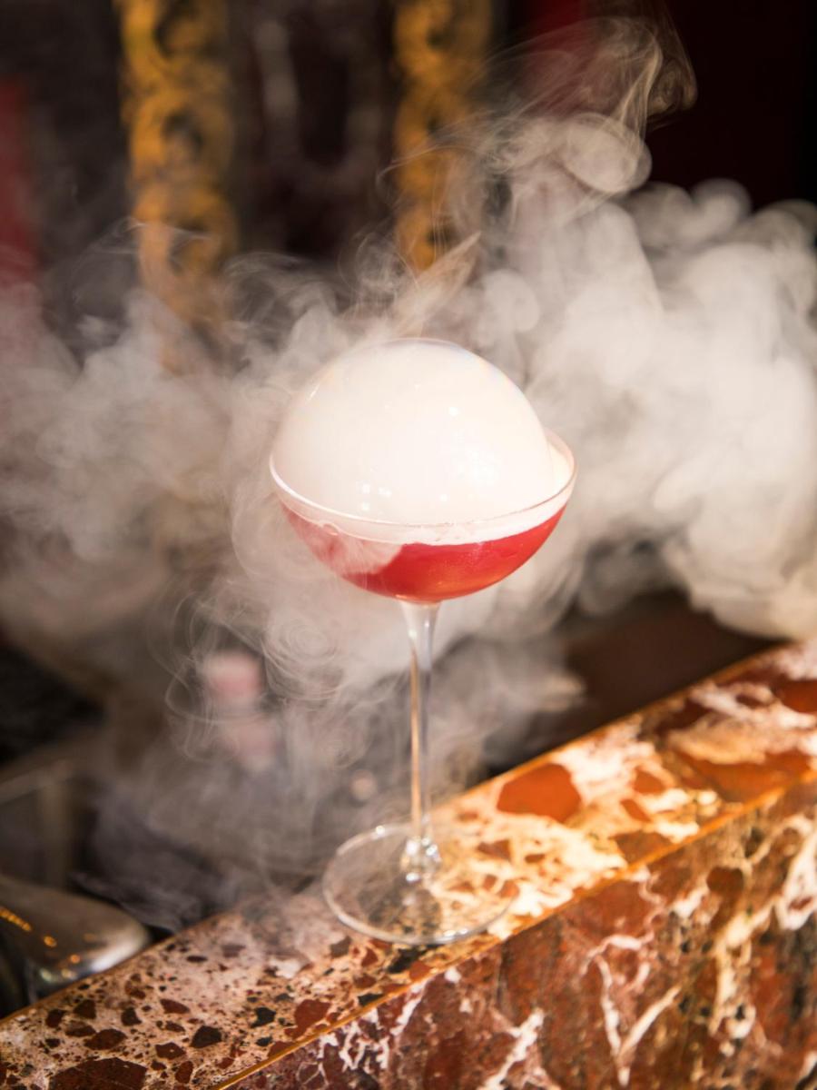 a drink in a wine glass with smoke at The Leela Ambience Gurugram Hotel & Residences - The Luxury Urban Sanctuary in Gurgaon