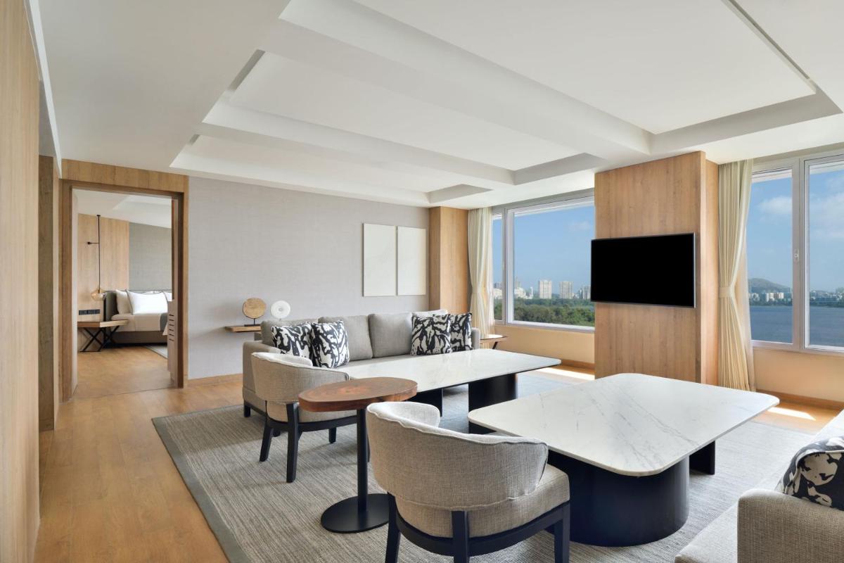 a living room with a couch and a table at The Westin Mumbai Powai Lake in Mumbai