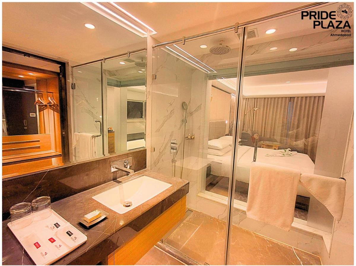 a bathroom with a sink and a shower at Pride Plaza Hotel, Ahmedabad in Ahmedabad