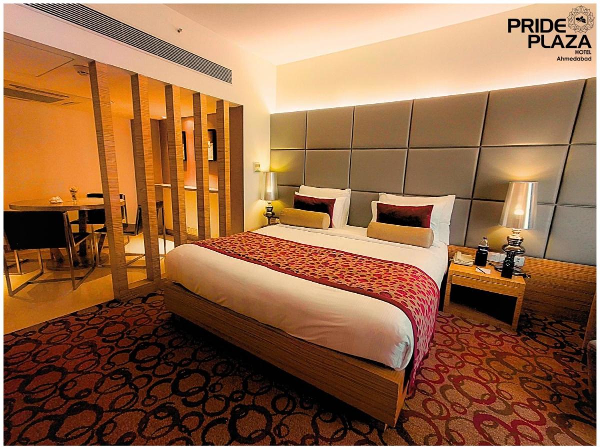 a bedroom with a large bed in a hotel room at Pride Plaza Hotel, Ahmedabad in Ahmedabad