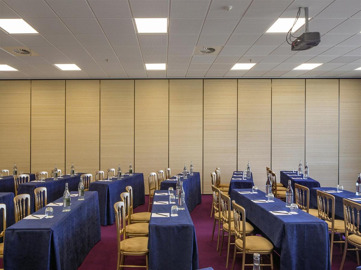 uma sala com mesas e cadeiras com mesas azuis e chairsearcher em Royal Obidos Scenic Resort em Praia del Rei mais 94 fotografias