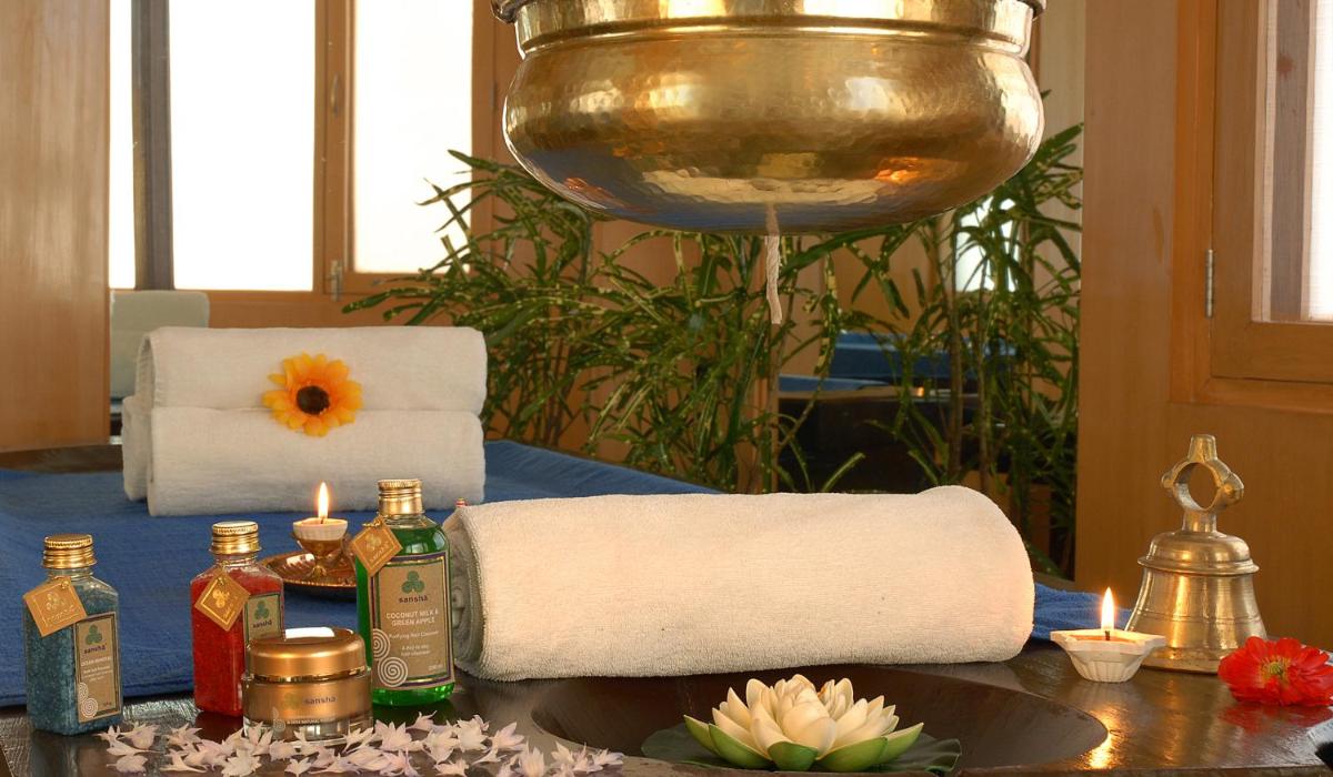 a table with towels and candles on a table at Radisson Hotel Shimla in Shimla