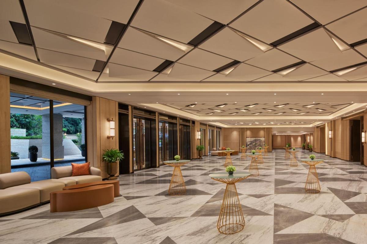 a lobby of a hotel with couches and tables at JW Marriott Mumbai Juhu in Mumbai